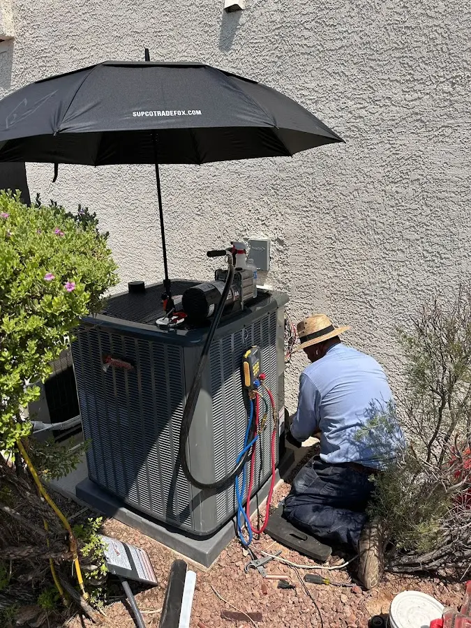 HVAC technician performing outdoor AC maintenance in Napoleon